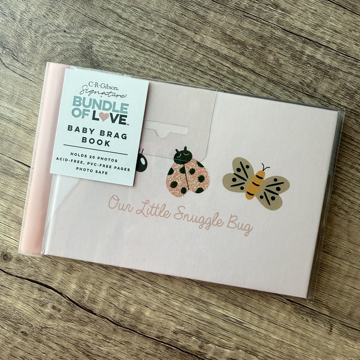 A baby photo book package labeled 'Bundle of Love Baby Brag Book' by C.R.