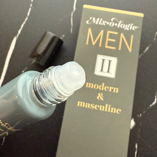 Perfume bottle and packaging with 'Mix-o-logic Men II' on a dark surface