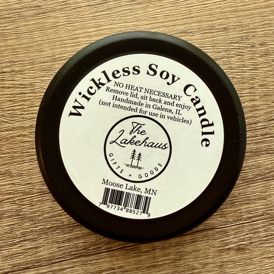 Wickless Soy Candle lid with 'The Lakehaus' branding on a wooden surface