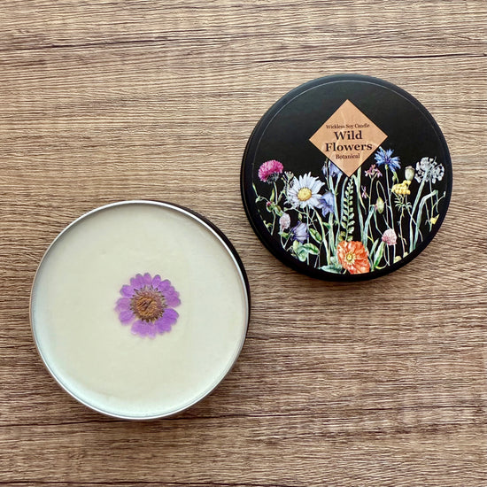 Cosmetic container with lid featuring floral design on a wooden surface
